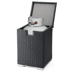 Opening the lid of the black wicker propane tank cover table to place a propane tank inside
