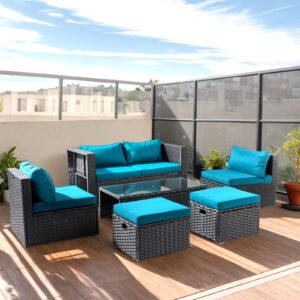 Outdoor wicker sofa set arranged on a villa rooftop terrace with green cushions