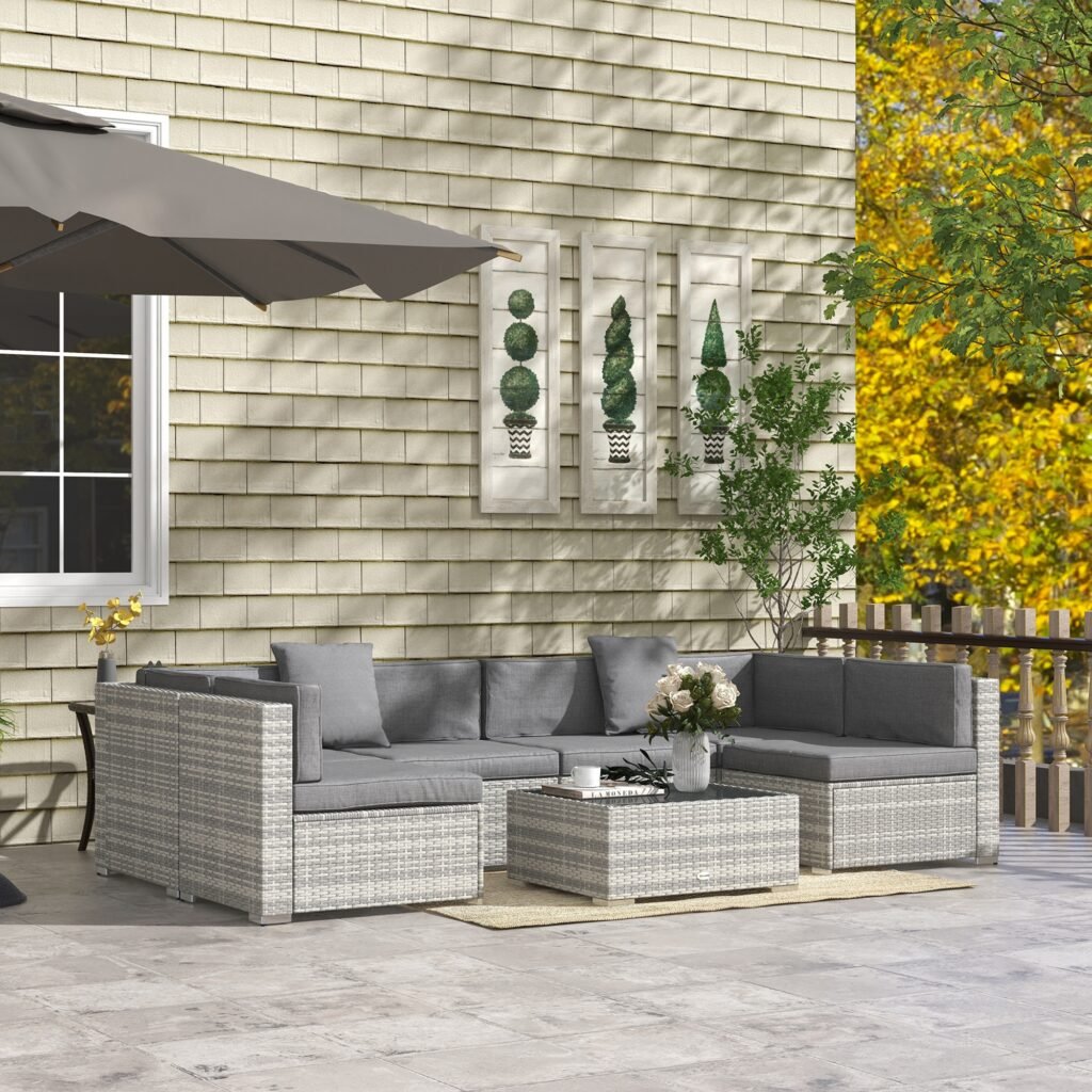U-shaped rattan sectional sofa arranged on an outdoor patio with a coffee table in the center