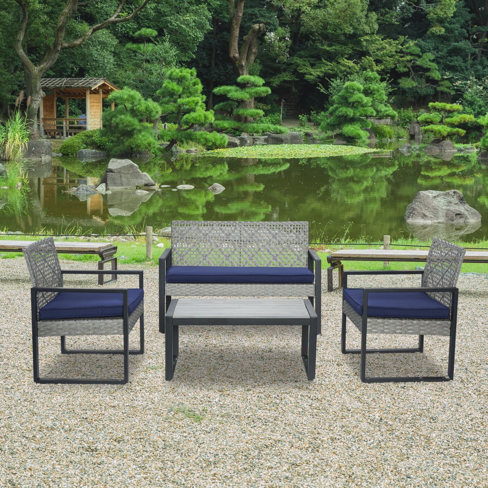 4-piece gray rattan patio sectional set arranged in garden setting beside a pond