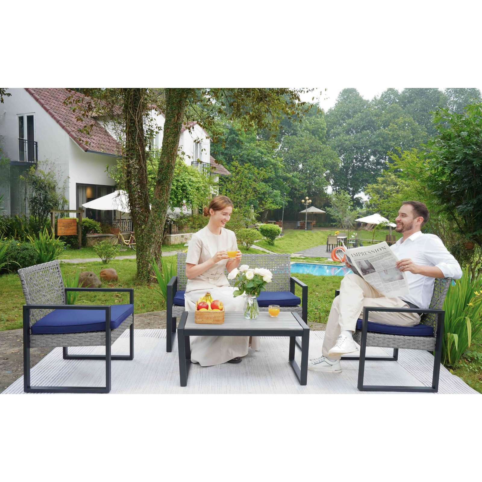 Couple relaxing on gray rattan patio sectional set in rustic courtyard setting