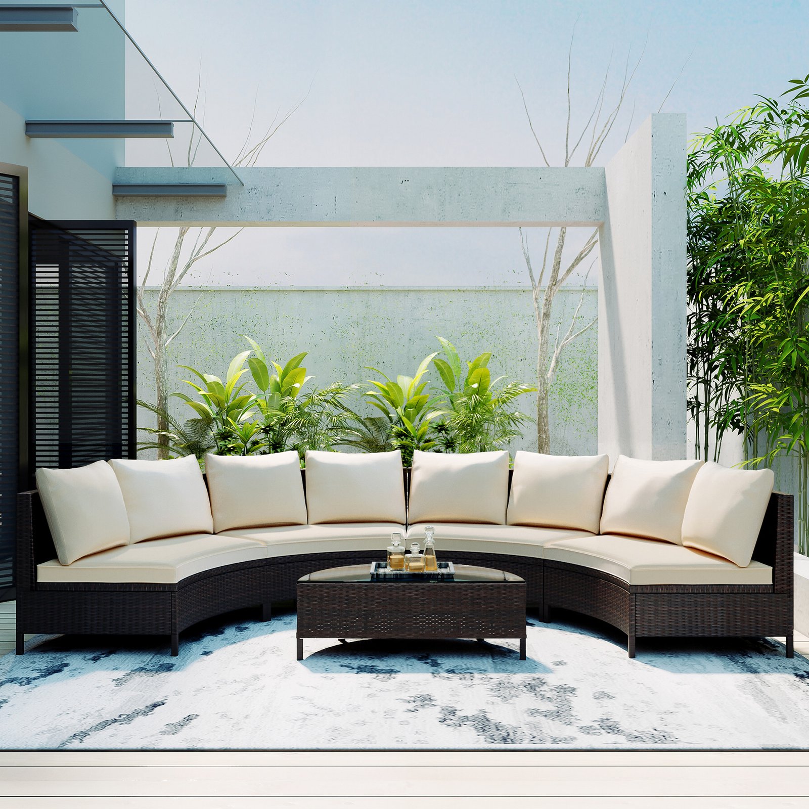 5-piece brown rattan half-moon sectional set with beige cushions in courtyard with tea on tempered glass table