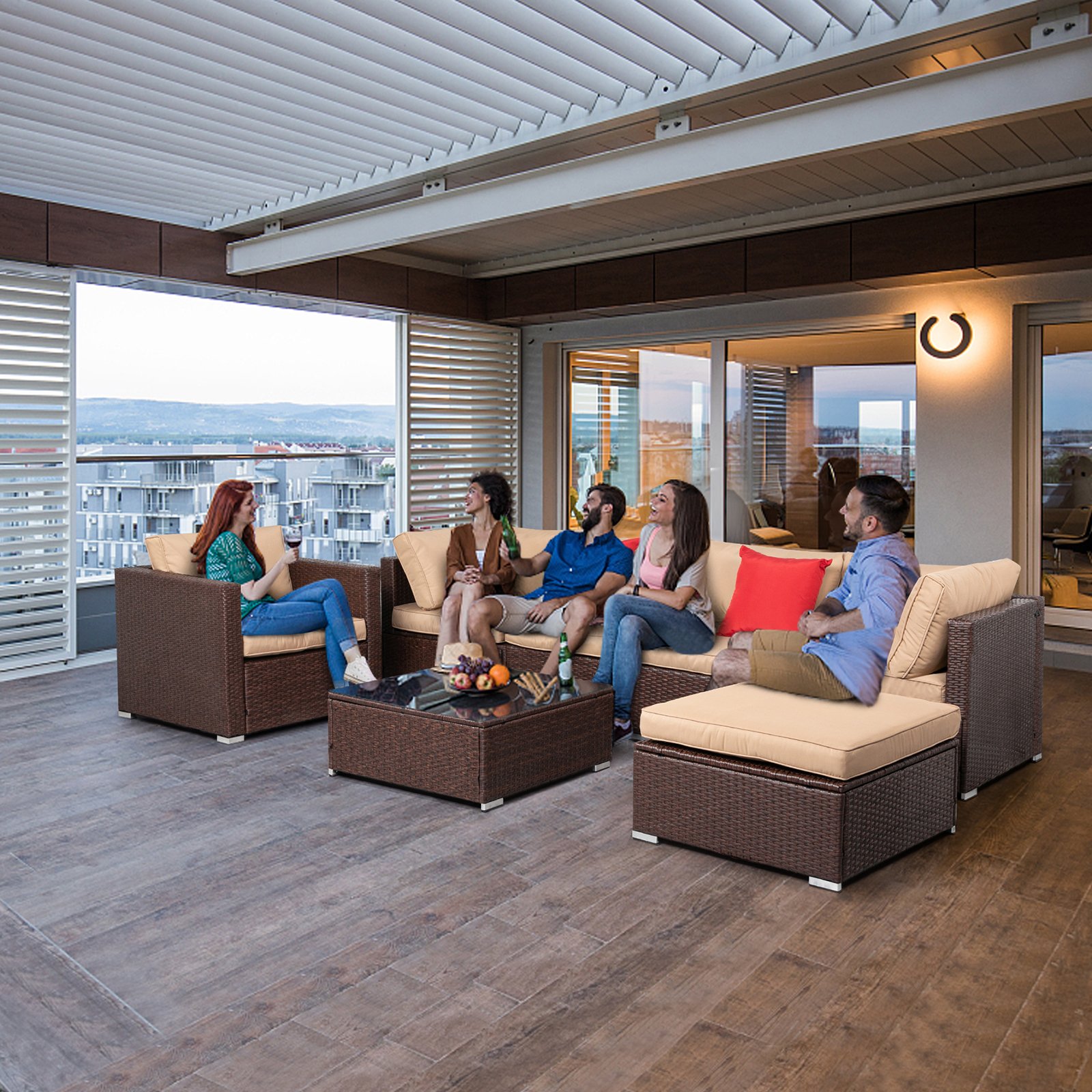 Group of friends relaxing on a 7-piece wicker patio sectional, enjoying drinks and conversation outdoors
