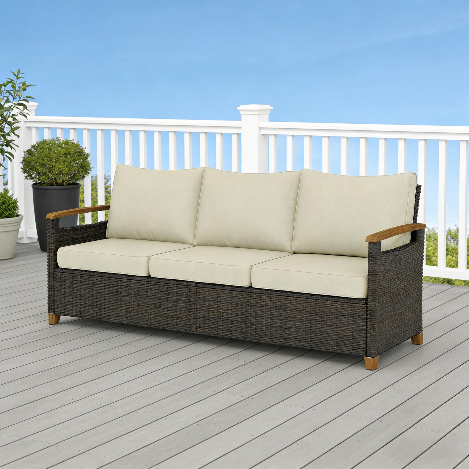3-seater brown wicker patio sofa with beige cushions placed on an outdoor patio deck
