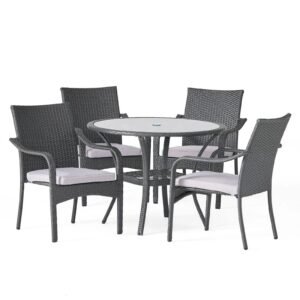 Gray rattan patio dining set with 4 gray cushioned chairs and glass table seats 4