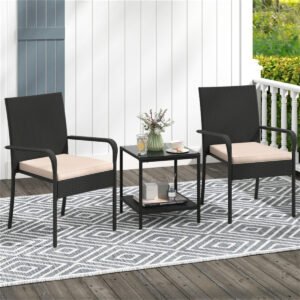 black rattan patio bistro set for 2 with beige cushions placed on a small balcony with coffee on the table
