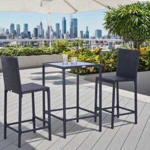 3-piece black rattan outdoor bar set with glass top table and 2 bar stools on an urban balcony with city skyline