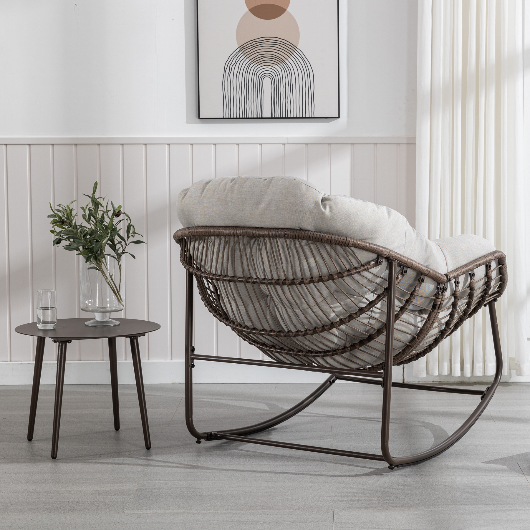 back view of oversized outdoor rattan rocking chair with brown wicker frame