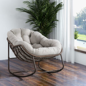 oversized outdoor rattan rocking chair with beige cushion and brown wicker frame