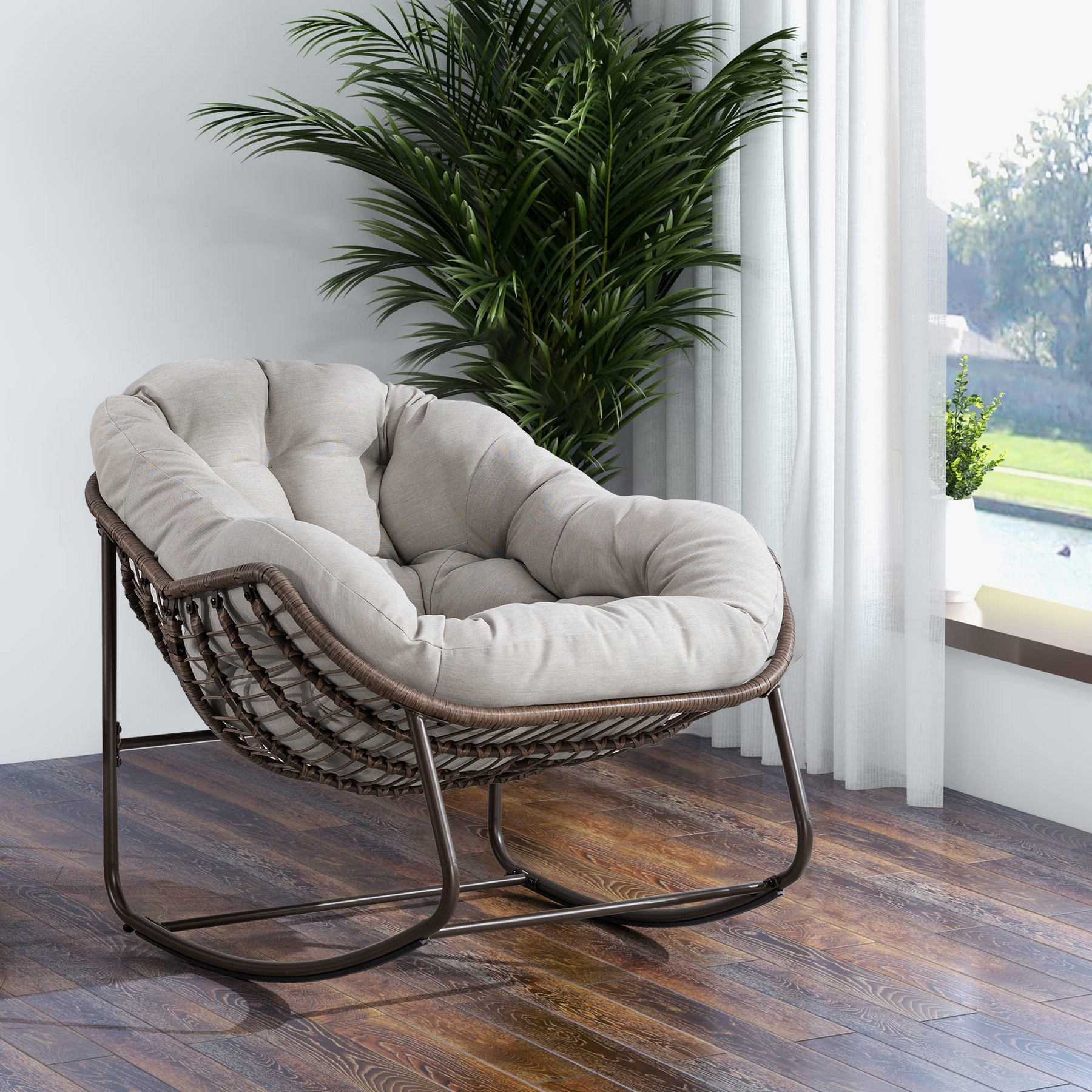 oversized outdoor rattan rocking chair with beige cushion and brown wicker frame
