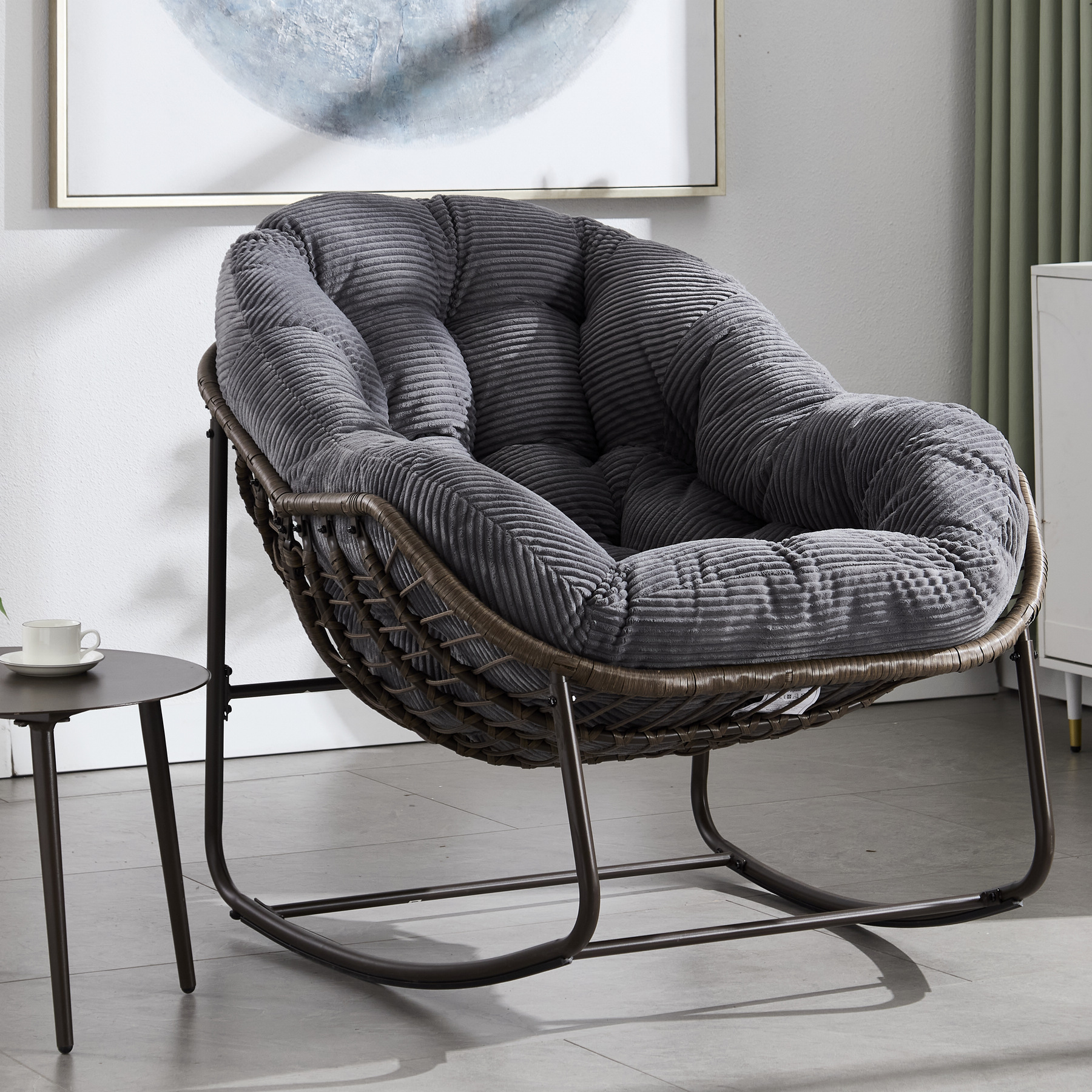 oversized outdoor rattan rocking chair with charcoal gray cushion and brown wicker frame