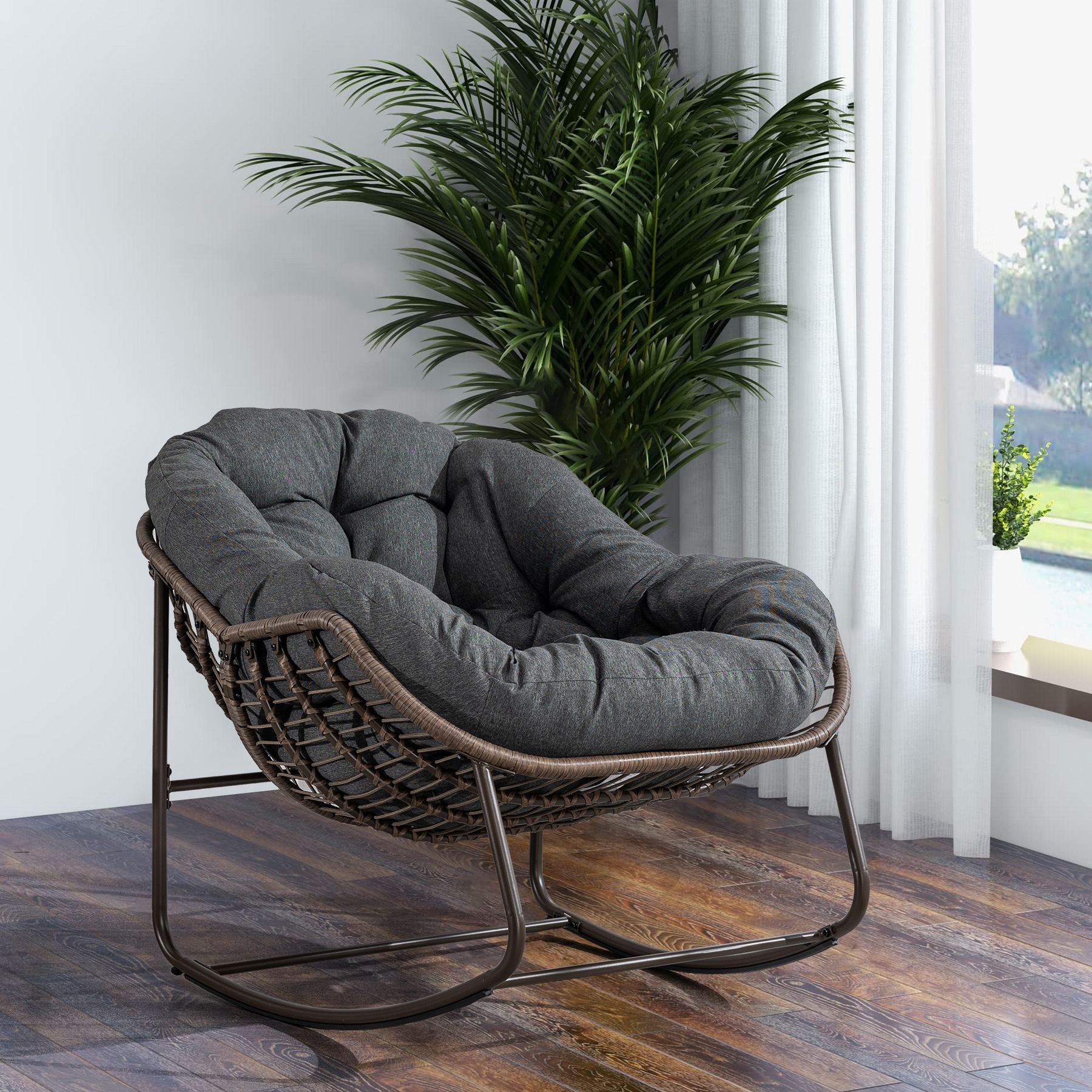 oversized outdoor rattan rocking chair with gray cushion and brown wicker frame