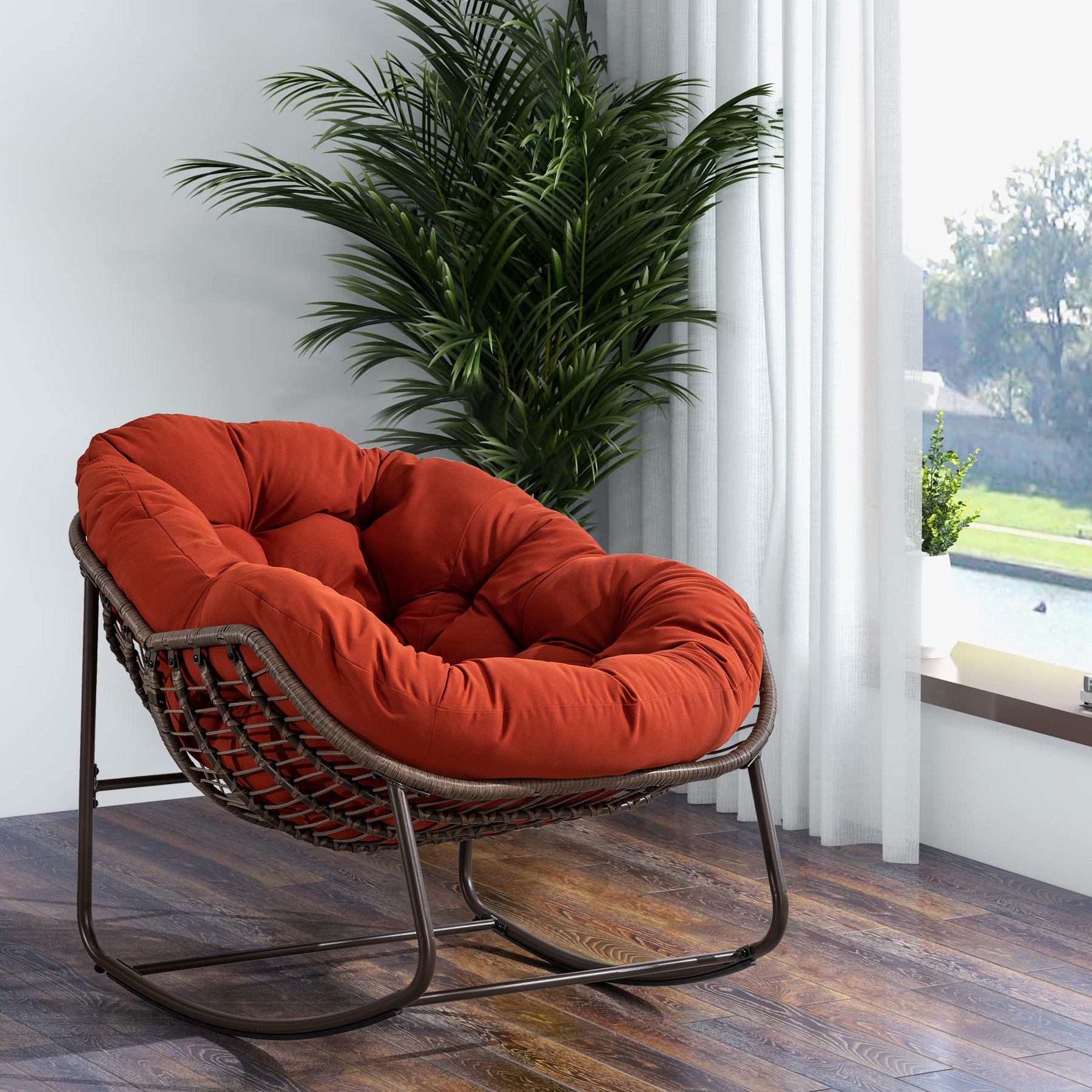 oversized outdoor rattan rocking chair with orange cushion and brown wicker frame