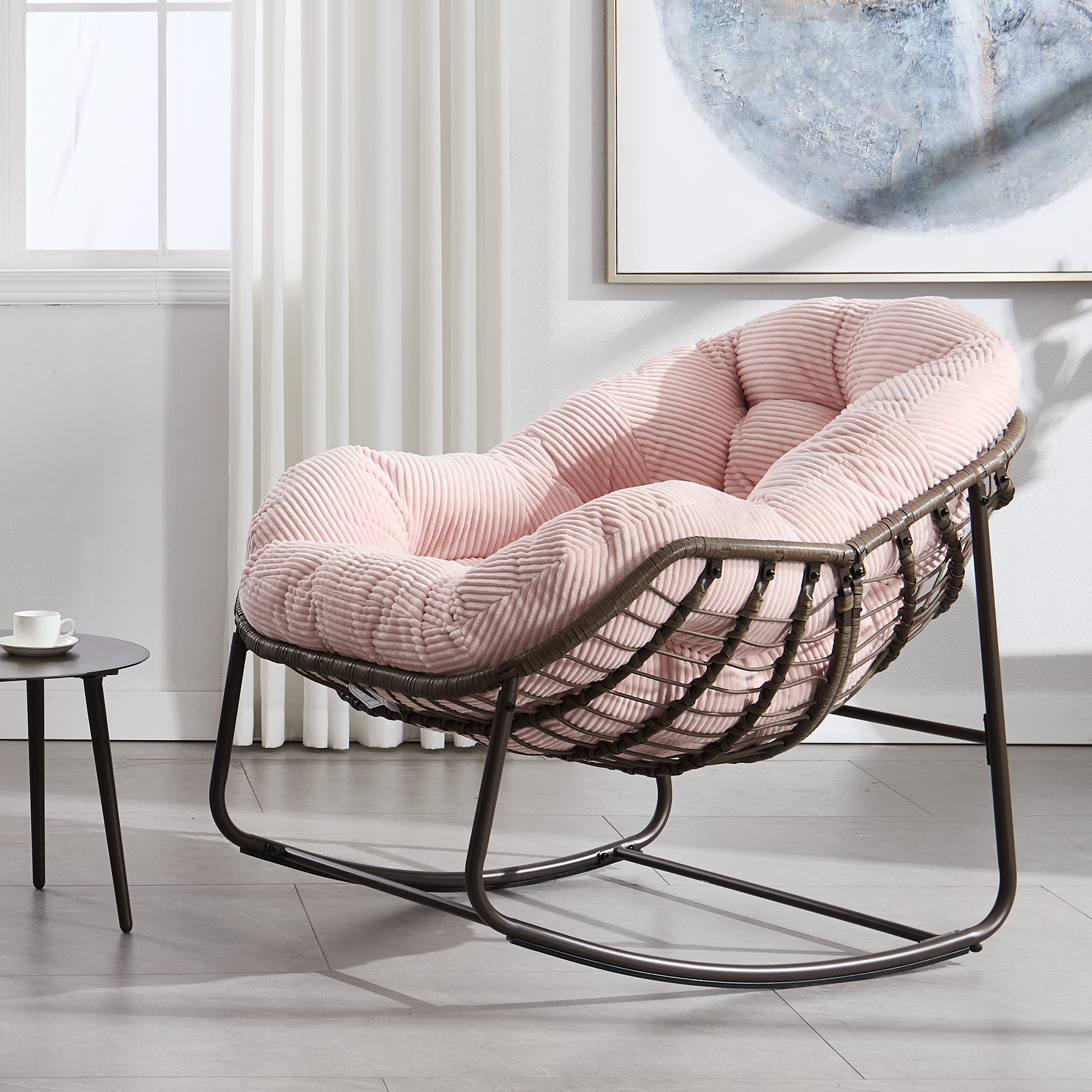 oversized outdoor rattan rocking chair with pink cushion and brown wicker frame