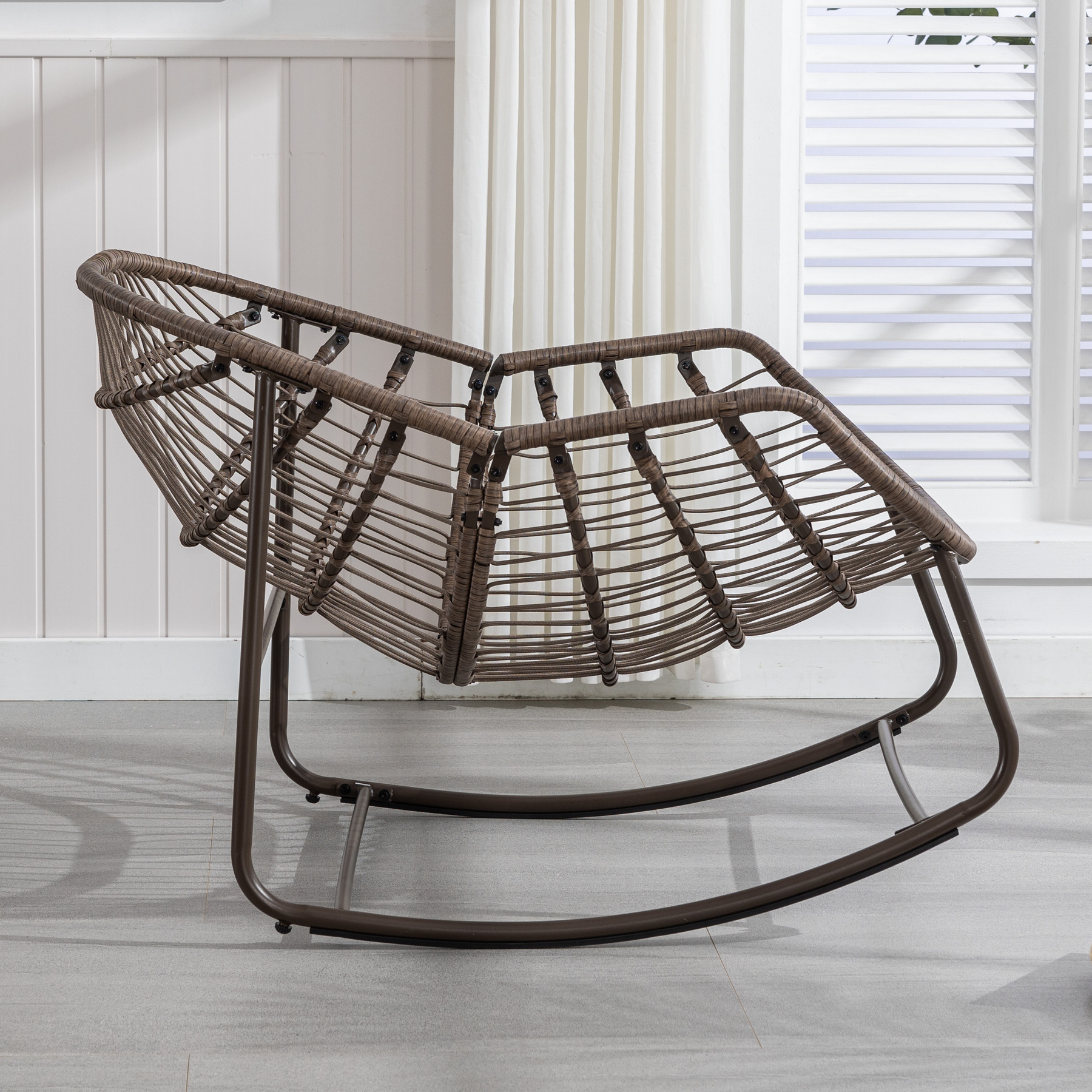 side view of oversized outdoor rattan rocking chair without cushion showing wicker frame