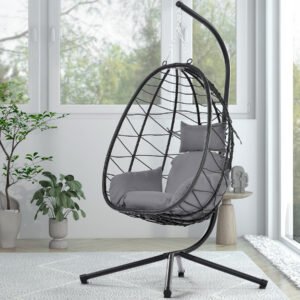 Single person cream PE rattan hanging egg chair with a plush Dark Gray cushion on a sunny farmhouse patio.