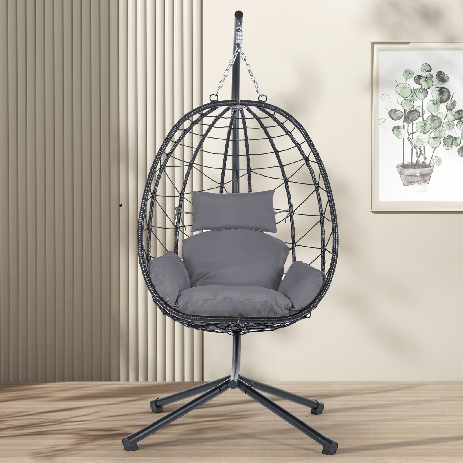 Front view of the dark gray wicker hanging egg chair with a matching plush cushion, styled on a modern outdoor patio.