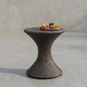 A slim hourglass-shaped wicker outdoor end table in a brown finish, showcasing its elegant tapered silhouette and compact circular top.