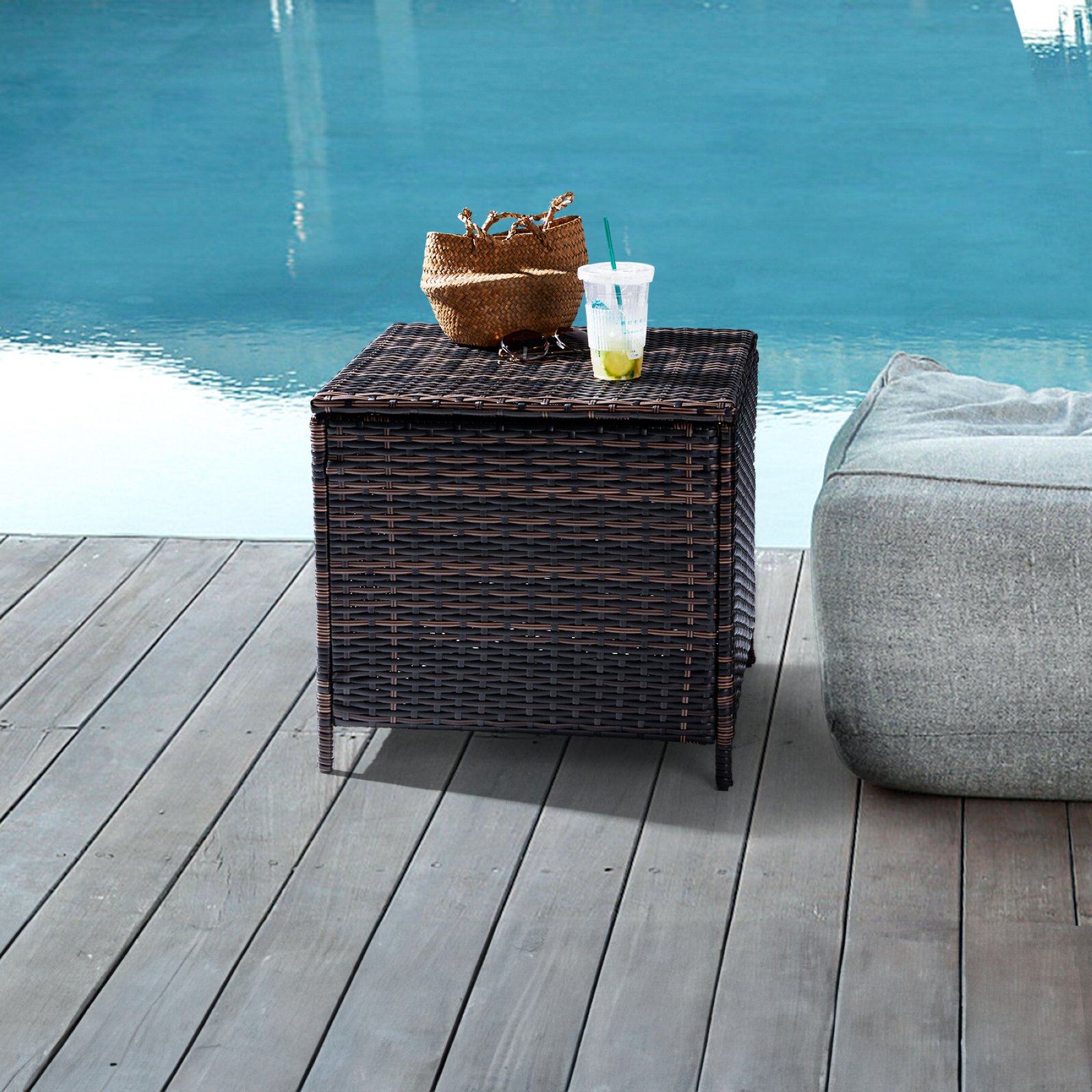 Brown outdoor wicker storage side table with drinks beside a pool for patio relaxation